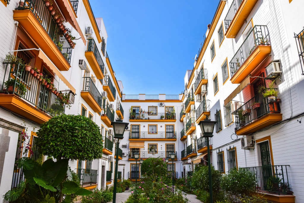 Residential buildings with balconies and planting in Seville.